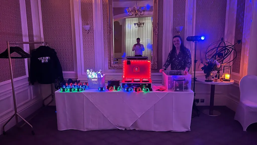Silent disco headphones and party lights set out on a table at a venue, ready for guests.
